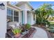 Front porch with wicker seating and lush landscaping at 21434 Preservation Dr, Land O Lakes, FL 34638