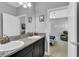 Bathroom with double sinks, granite countertop, and view of bedroom at 2847 Calvano Dr, Land O Lakes, FL 34639