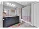 Bathroom with dark vanity, granite countertop, and pink accents at 2847 Calvano Dr, Land O Lakes, FL 34639