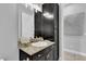 Modern bathroom with dark cabinetry and granite countertop at 2847 Calvano Dr, Land O Lakes, FL 34639