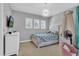 Bedroom with large bed, chandelier, and teal accents at 2847 Calvano Dr, Land O Lakes, FL 34639