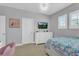 Bright bedroom with a comfortable bed, dresser, and large window at 2847 Calvano Dr, Land O Lakes, FL 34639