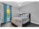 Bright bedroom with teal curtains and modern decor at 2847 Calvano Dr, Land O Lakes, FL 34639