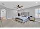 Main bedroom with king-size bed and ceiling fan at 2847 Calvano Dr, Land O Lakes, FL 34639