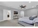 Main bedroom with a king bed, TV, and access to bathroom at 2847 Calvano Dr, Land O Lakes, FL 34639