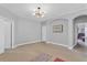 Spacious bedroom with carpeted floor, large windows, and ceiling fan at 2847 Calvano Dr, Land O Lakes, FL 34639