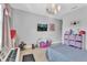 Bedroom with twin bed, toys, and pink storage at 2847 Calvano Dr, Land O Lakes, FL 34639