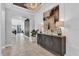 Bright entryway with tile floors, console table, and large art piece at 2847 Calvano Dr, Land O Lakes, FL 34639