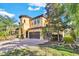 Two-story house with a two-car garage, brick driveway, and lush landscaping at 2847 Calvano Dr, Land O Lakes, FL 34639