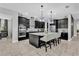 Gourmet kitchen with island, stainless steel appliances, and dark cabinetry at 2847 Calvano Dr, Land O Lakes, FL 34639