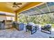 Outdoor kitchen with stainless steel appliances and stone countertops at 2847 Calvano Dr, Land O Lakes, FL 34639