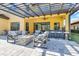 Covered patio with seating area, fire pit, and outdoor kitchen at 2847 Calvano Dr, Land O Lakes, FL 34639
