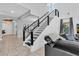 Modern staircase with metal railing and dark wood accents at 2847 Calvano Dr, Land O Lakes, FL 34639