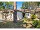 Tan colored house with attached garage and landscaping at 2902 Oak Cir, Tarpon Springs, FL 34689