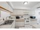 Clean, well-lit kitchen featuring white cabinetry and appliances at 2902 Oak Cir, Tarpon Springs, FL 34689