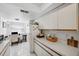 Bright kitchen with white cabinets, offering ample counter space at 2902 Oak Cir, Tarpon Springs, FL 34689