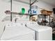 Convenient laundry room with washer, dryer, and ample storage shelving at 2902 Oak Cir, Tarpon Springs, FL 34689