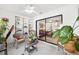 Bright sunroom with wicker furniture and built-in shelving, offering a relaxing space at 2902 Oak Cir, Tarpon Springs, FL 34689