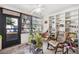 Relaxing sunroom featuring wicker chairs, built-in shelving, and access to the outdoors at 2902 Oak Cir, Tarpon Springs, FL 34689