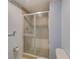 Bathroom featuring a glass sliding door shower, and a toilet at 30 Turner St # 201, Clearwater, FL 33756