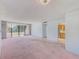 Spacious living room with sliding glass doors to the balcony and adjacent kitchen at 30 Turner St # 201, Clearwater, FL 33756