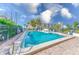Outdoor pool area surrounded by palm trees and a building in the background at 30 Turner St # 201, Clearwater, FL 33756