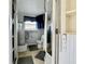 Clean bathroom with toilet, shower, and a stacked washer and dryer at 35127 Danny Dr, Zephyrhills, FL 33541