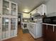 Kitchen with white cabinets and mosaic backsplash at 35127 Danny Dr, Zephyrhills, FL 33541