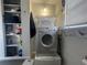 Well-equipped laundry room with washer, dryer, storage, and shelving at 35127 Danny Dr, Zephyrhills, FL 33541