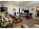 Bright and airy living room with ample seating and a view into another room at 35127 Danny Dr, Zephyrhills, FL 33541