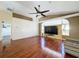 Spacious living room with hardwood floors and a large TV at 4076 Breckland Ct, Spring Hill, FL 34609