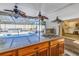 View of a kidney shaped pool and spa from the outdoor kitchen at 4925 Alcazar S Way, St Petersburg, FL 33712