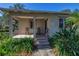 Front porch with rocking chairs and a walkway to the front door at 4925 Alcazar S Way, St Petersburg, FL 33712