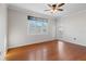 Bedroom with hardwood floors, large window, and access to balcony at 501 Knights Run Ave # 1217, Tampa, FL 33602