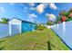 View of backyard, showing grassy area and teal garage at 5322 6Th N Ave, St Petersburg, FL 33710