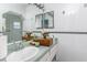 Bathroom with white tile, a sink, and a large mirror at 635 Hudson Ave, Tampa, FL 33606