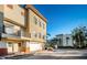 Townhouse with balcony, two-car garage, and lush landscaping at 643 Blue Taverna Ln, Clearwater, FL 33756