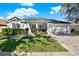 White two-story house with a three-car garage and landscaped front yard at 7023 Derwent Glen Cir, Land O Lakes, FL 34637