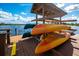 Kayaks and canoes on a wooden rack by the lake at 7023 Derwent Glen Cir, Land O Lakes, FL 34637