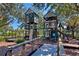 Community playground with a large wooden play structure at 7023 Derwent Glen Cir, Land O Lakes, FL 34637