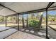 Relaxing screened porch overlooking a lush green backyard at 7106 Riverwood Blvd, Tampa, FL 33615