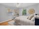 Bright bedroom with wood floors, neutral decor, and ample natural light at 7611 Dartmouth N Ave, St Petersburg, FL 33710