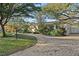 House with a brick driveway and lush landscaping at 7611 Dartmouth N Ave, St Petersburg, FL 33710