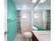 Bathroom with teal walls, walk-in shower, and a vanity with a granite countertop at 8015 Idlebriar Ln, Port Richey, FL 34668