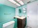 Bathroom with teal walls, double vanity, and a granite countertop at 8015 Idlebriar Ln, Port Richey, FL 34668
