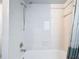 Clean bathroom featuring a shower/tub combo and tile surround at 8015 Idlebriar Ln, Port Richey, FL 34668