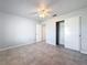 Spacious bedroom featuring tile flooring and a sizable closet at 8015 Idlebriar Ln, Port Richey, FL 34668