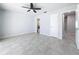 Spacious bedroom with tile floors and ceiling fan at 8015 Idlebriar Ln, Port Richey, FL 34668