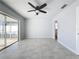 Bedroom with tile floors, ceiling fan, and pool view at 8015 Idlebriar Ln, Port Richey, FL 34668