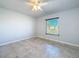 Spacious bedroom with ceiling fan and large window at 8015 Idlebriar Ln, Port Richey, FL 34668